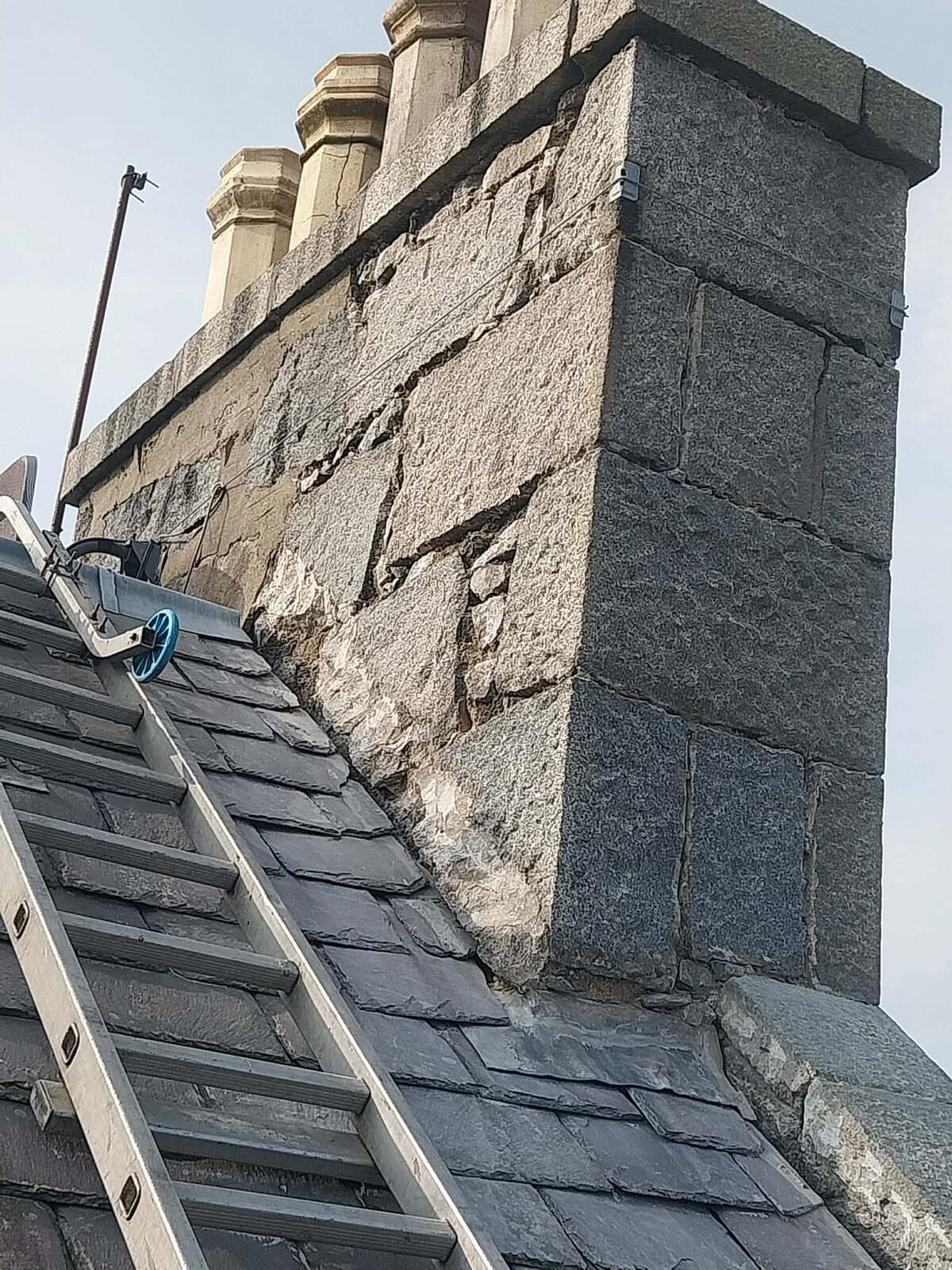 Eroded mortar joints on a granite chimney stack in Aberdeen