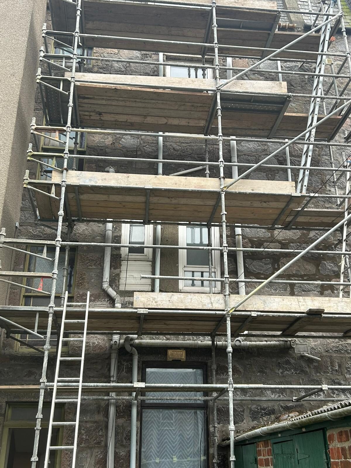Scaffolding tiers erected on a granite tenement in Aberdeen